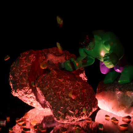 Lego Hulk using his fist to smash, and crack in half, a boulder